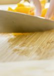 Cutting board and yellow peppers